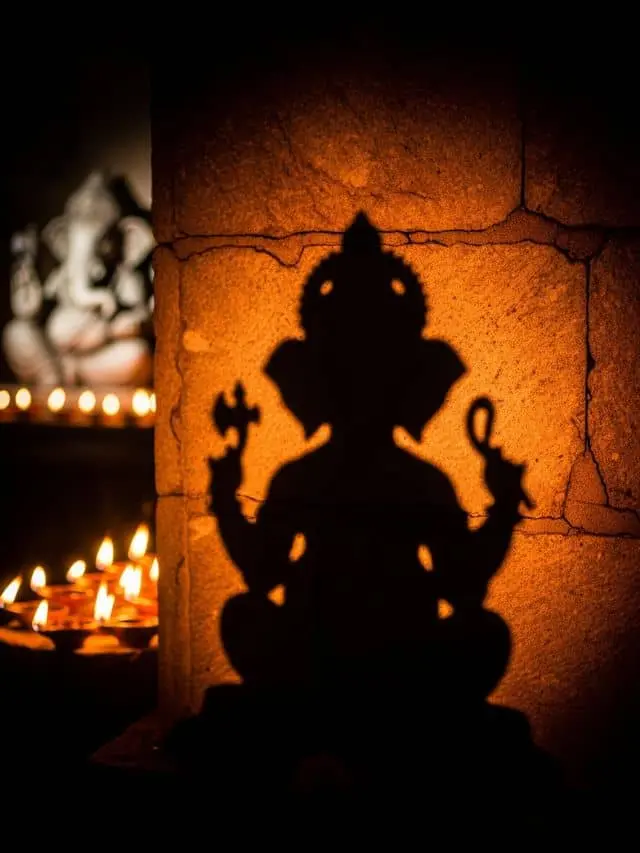 Ganesh Chaturthi mystery shadow poster – glowing Ganesha silhouette with diyas and suspenseful aura.